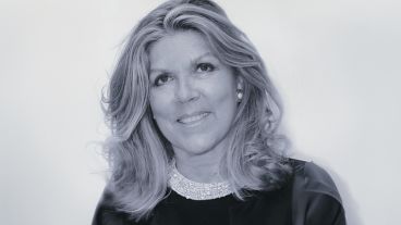 Lavinia Branca Snyder. Smiling woman in a black and white photo, wearing a beaded collar.