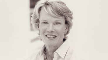 Smiling woman with short hair in a monochrome photograph.