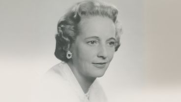 Black and white portrait of a woman with curled hair and earrings.
