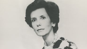 Black and white portrait of a woman with short hair and patterned attire.