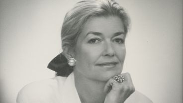 Black and white portrait of a woman with pearl earrings and a thoughtful expression.