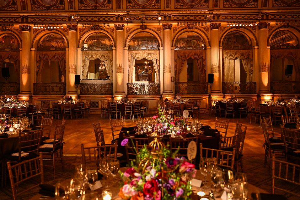 The elegant ballroom of the Plaza Hotel on event night.
