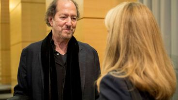 MSK patient and jazz musician Michael Wolff, dressed in black and standing, smiles in conversation. 